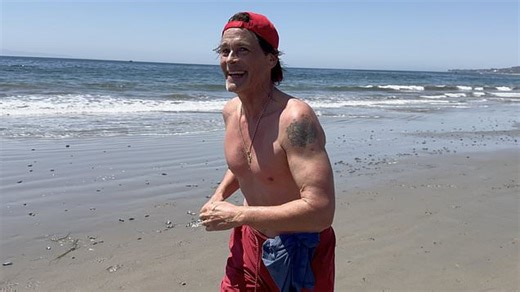 Rob Lowe flaunts toned physique as he enjoys a run on the beach