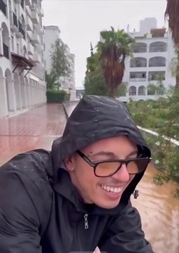 WATCH: Flooding in Spain | Man rides inflatable mattress in flood waters