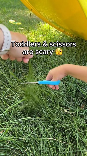 Jamie Robinson, M.A.Ed. | Early Learning + Parenting on Instagram: "Toddlers & scissors = terrifying… but also a necessary skill! A fun way to practice scissor cutting is to cut the grass outside! A little tip for kids with longer hair, pull it into a bun! I honestly think I’m less worried they will cut their finger and more worried those scissors will find their way to their hair. 💇‍♀️ Have you tried cutting grass? What other things have you had your child cut that isn’t paper? #momsofinstagra