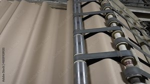 Processing Cardboard in a Paper Mill close-up. Carton Processing at a Factory. Production line for the production of cardboard and corrugated cardboard in the factory