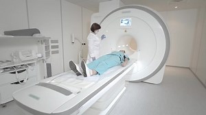 clip-1058310091-doctor-performs-mri-scan-patient-clinic-girl