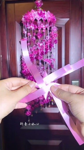 The pink, light pink, and fuchsia ribbon wind chimes,
