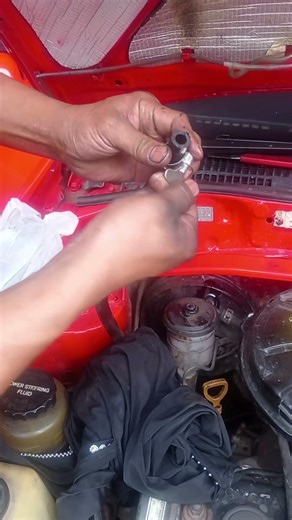 Installing the car engine oil hose.