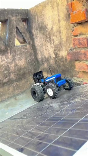 Mini Tractor Playing Among Solar Panels