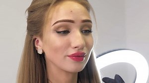 Beauty injections. Lip augmentation procedure. Lip injection. The cosmetologist in medical gloves looks at the result after the injection of the female patient. Lip injection plastic surgery.