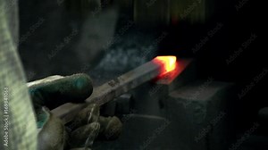 Blacksmith using power hammer