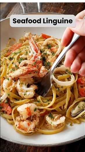 If you love elegant, restaurant-style pasta at home, this Seafood Linguine will steal your heart with every bite. Ingredients 12 oz linguine 1 lb shrimp, peeled and deveined 8 oz calamari rings 3 tbsp olive oil 4 cloves garlic, minced ½ tsp red pepper flakes (optional) 1 cup seafood or chicken broth ½ cup heavy cream (optional for richness) Zest of 1 lemon 2 tbsp fresh lemon juice ¼ cup freshly grated Parmesan cheese Salt and black pepper, to taste Fresh parsley, chopped (for garnish) Preparatio