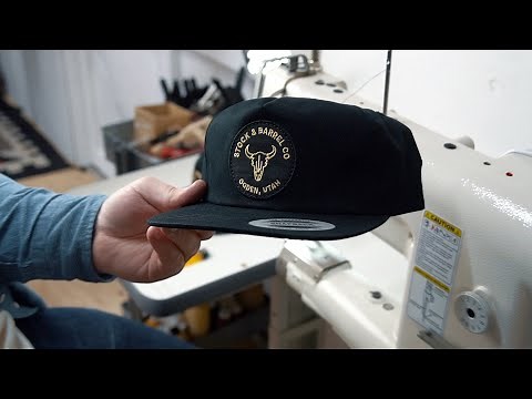 Using a leather sewing machine to sew a patch on a 5 panel hat