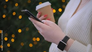 Finger of woman touching scroll page app on mobile phone. Relaxed young woman using smart phone surfing social media, checking news, playing mobile games or texting messages on mall. Millennial lady