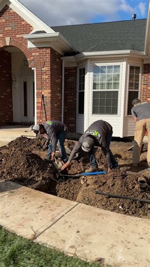 Digging out and preparing the front landscape for a new retaining wall installation.