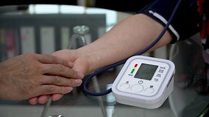 Download Doctor checking old female patient arterial blood pressure. Health care.Monitoring blood pressure of patients using upper arm blood pressure monitor in the for free