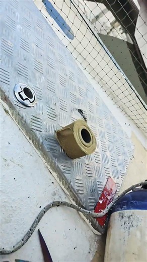 water proofing my anchor winch motor with denso tape . while under the Dink oh what fun boats are