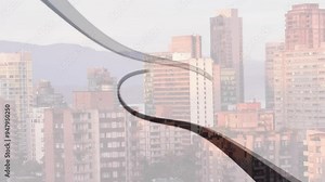 Curved lines animation over cityscape with buildings and mountains in background