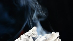 Burning paper on a black background - Free Stock Video