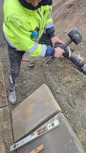 Construction Worker Setting Metal Stake with Precision