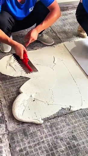 Tile steadied, red tool hums, slab yields—cutting line etched in stone’s face