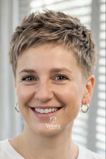 Short brown pixie haircut defined by a clean tapered nape and subtly layered texture on top ✂️