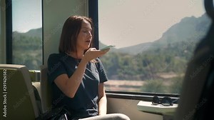 Phone voice audio message ai speech recognition. Young stylish fashion girl student woman traveling phone looking out the window while sitting in the train lookbook sun flares subway underground