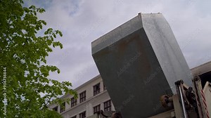 Massive garbage can collection truck emptying and processing trash