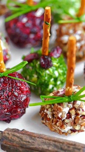 Mini Goat Cheese Balls Ingredients: 8 oz goat cheese, softened 4 oz cream cheese, softened (for creamier texture) ½ tsp garlic powder ½ tsp dried thyme or rosemary (optional) ¼ cup chopped fresh parsley ¼ cup finely chopped pecans (toasted for extra flavor) 2 tbsp dried cranberries, finely chopped Freshly ground black pepper (to taste) Pretzel sticks or toothpicks (for serving) Directions: In a bowl, combine the goat cheese, cream cheese, garlic powder, and herbs (if using). Mix until smooth and