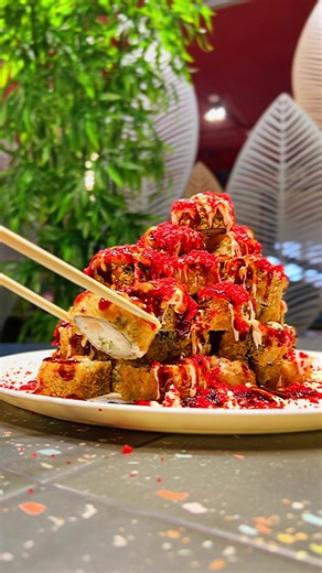 Delicious Sushi Stack with Red Sauce and Drizzle