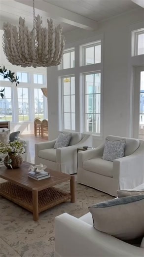 "My dream living room from Pottery Barn 🐚 The York Sofa, York Chairs, and woven details all create the dreamiest beach house living room. We have fallen in love with the York Sofa- it’s VERY comfortable & has performance fabric so stains & spill clean up easily 🙌🏻" Shop @emilyannetravis's space: https://bit.ly/4tSXH41 | Pottery Barn