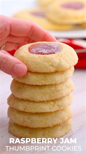 Melt-in-your-mouth raspberry thumbprint cookies are tender with a delicious burst of raspberry fruit jam in the center. This classic cookie is soft, sweet and one of my favorites for the holidays. ♥️ Recipe: https://onmykidsplate.com/raspberry-jam-thumbprint-cookies/ | On My Kids Plate
