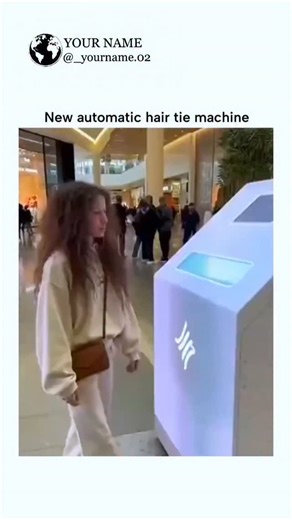 Your Name on Instagram: "The video showcases a woman using a mall kiosk-style machine to automatically tie her long hair into a neat bun in seconds, with Spanish subtitles expressing excitement, amassing over 130,000 views shortly after posting. Replies highlight skepticism and humor, questioning if it's Al-generated or real, with jokes about malfunctions leading to "Final Destination"-style accidents or lice sponsorships. This aligns with a November 2025 trend of fabricated Al videos depicting