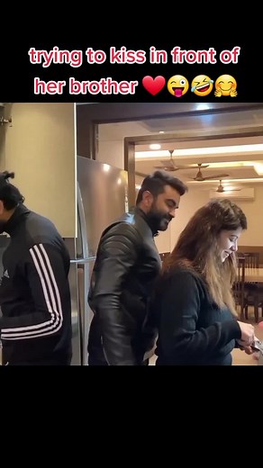 Hilarious Indoor Prank: Kiss Attempt in Front of Brother