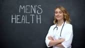 Doctor standing near Mens health inscription, importance of annual...