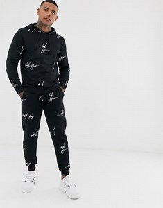 ASOS DESIGN two-piece in black with all over dark future logo print | ASOS