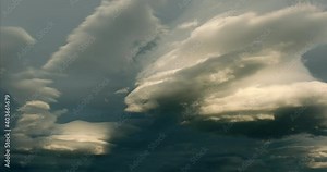 Scenic cirrus lenticular clouds timelapse with awesome crepuscular rays and light effects surrounded by a mystical golden hour twilight. Bizarre atmospheric phenomenon locked cinematic pick-up shot.