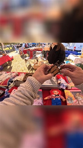 A shopper fondly remembers Annie dolls, buys one, and then adds a Barbie to the collection at an outdoor market. A sweet reminder of childhood joy. #AnnieDoll #BarbieDoll #Nostalgia #OutdoorMarket #ChildhoodMemories | ADHDave