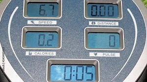 The display panel on the exercise machine. The display shows speed, time, distance and burned calories on the training machine. Control panel at fitness equipment.
