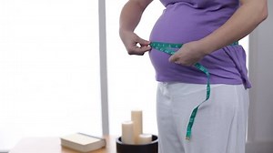 Pregnant woman measuring belly