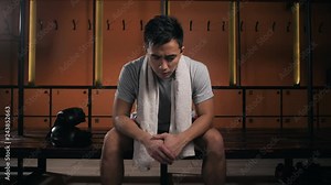 Muscular asian man with a towel. Caring for your body after a hard workout. athlete in dressing room. Chinesse korean boxer after training serious tired Stock Video