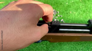 Video of a hand reloading a shotgun with pellets Stock Video