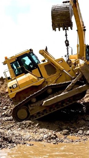 A Dozer was working near the shore and fell into the water. Excavator to help.