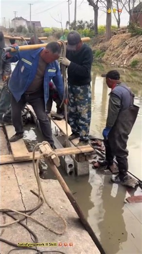 This is how rural men assemble concrete fence for embankment