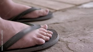 Child Moving Dirty Bare Feet, Wiggling Fingers, Doing Relaxation Exercises. Close-up of tired children's legs and toes in flip-flops. Recovery of strength. Earth, sand. Rest, long walk. Body part.