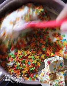 Rainbow Fruity Pebbles White Chocolate Fudge Ingredients: 3 cups white chocolate chips 1 can (14 ounces) sweetened condensed milk, at room temperature 2 tablespoons unsalted butter 1 teaspoon vanilla extract 4 cups Fruity Pebbles cereal Pinch of salt 1/2 cup chopped toasted almonds or toasted coconut (optional) Extra Fruity Pebbles cereal for decoration (optional) Directions: Prepare an 8-inch square pan by lining it with parchment paper, leaving an overhang on two sides so the fudge can be lift