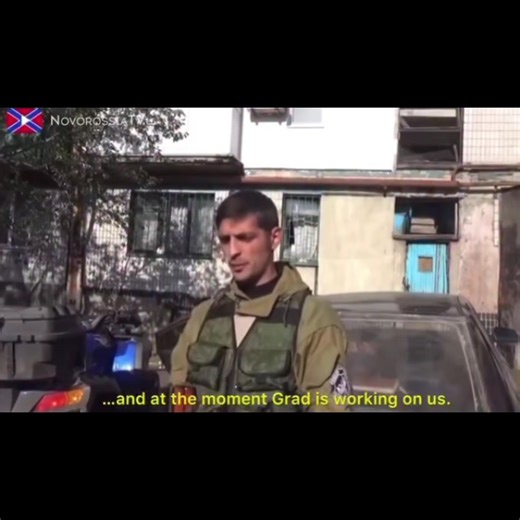 The famous clip showing Somali Battalion commander Mikhail «Givi» Tolstykh taking an interview from Novorossiya T.V. while Ukrainian Grads land nearby. This was filmed 5 Oct 2014. An ethnic Georgian, Givi grew up in Illovaisk (born 1980), and attended school there. Upon graduation, he took compulsory military service in the Ukrainian army from 1998 to 2000, and wanted to continue but was denied due to his speech impediment. He joined the rebels early on in the conflict, though how exactly he cam