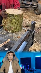 Efficient Log Splitting Process Using a Mechanical Splitter. Visual Description The video showcases wood processing activities in an open-air yard. The main focus is on a man wearing a red jacket and a black beanie operating a mechanical log splitter. In the background, there are abundant piles of wood and a blue tractor with a trailer, creating a productive and busy work environment. Activity Details * Machine Mechanism: This tool utilizes an automatic mechanical arm that moves back and forth c