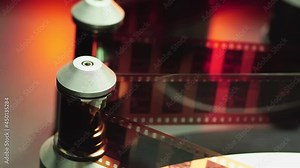 The machine is scanning 35 mm film to digital. Close up machine scanning motion picture film, Motion picture film scanner.