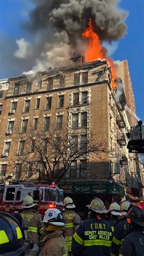 First images show flames erupting from windows and the roof as a massive fire engulfs an apartment building in New York. | Disaster & Extreme Weather