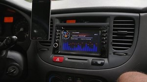 Baku, Azerbaijan - 11 01 2018: Baku, Azerbaijan: 01 NOV 18 - Close up shot of the interior of a car with stereo in use and a mobile phone sitting in a device holder