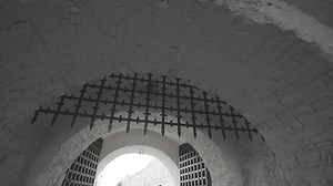 Suspended grid complements Kazan Kremlin grand entrance. Arched curves frame structure in timeless style demonstrating harmony of old and new