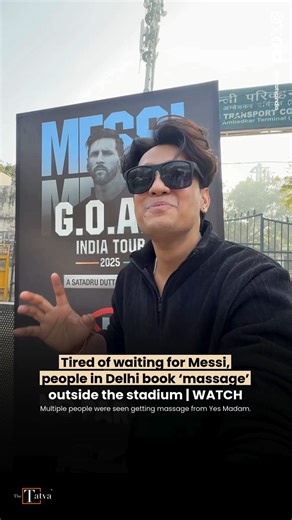 The Tatva on Instagram: "Fans waiting to catch a glimpse of Lionel Messi in Delhi found an unexpected way to kill time outside the stadium by booking massages on the footpath. Videos that surfaced on social media show multiple people lying on massage beds placed just outside the venue, with therapists from on-demand wellness service Yes Madam giving head and shoulder massages. The scenes played out as crowds gathered in large numbers, waiting for Messi’s arrival, which was delayed by hours. The