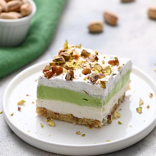 Recipe: https://therecipecritic.com/pistachio-dessert/ This layered pistachio dessert is insanely delicious! It has the perfect crust, topped with layers of creamy cheesecake and pistachio pudding. The crushed pistachios on the top finish it off and make it the best dessert for any occasion! | The Recipe Critic