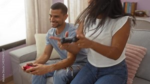 Couple enjoying together playful moment while engaging with video game controllers in cozy living room setting